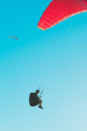 leisure activities person parachuting at daytime gliding